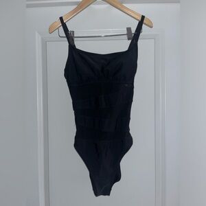 Black one-piece women’s Target swimsuit with sheer lines